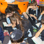 Students memorising a passage from book