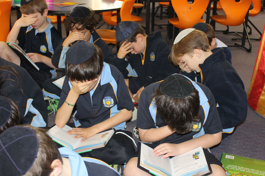 Students memorising passage from book