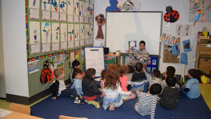 Masada staff reading a story for students