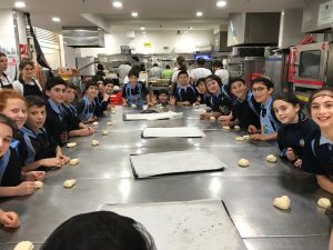 Students preparing to roll pastry bread 2