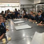 Students preparing to roll pastry bread