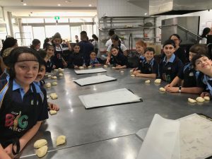 Students preparing to roll pastry bread