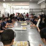 Students rolling dough in the kitchen