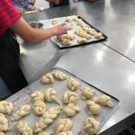 Students creating pastry bread