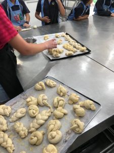 Students creating pastry bread