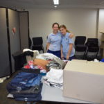 Students participating in packing clothes for charity