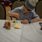 Young Masada student eating his meal