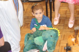 Young boy with dinosaur at PURIM