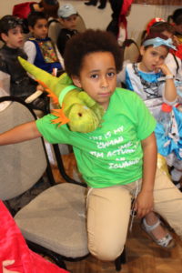 Student with a toy lizard at PURIM celebration