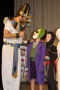 Our staff member with a student in costume on stage