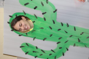Student with a cactus cutout at PURIM celebration